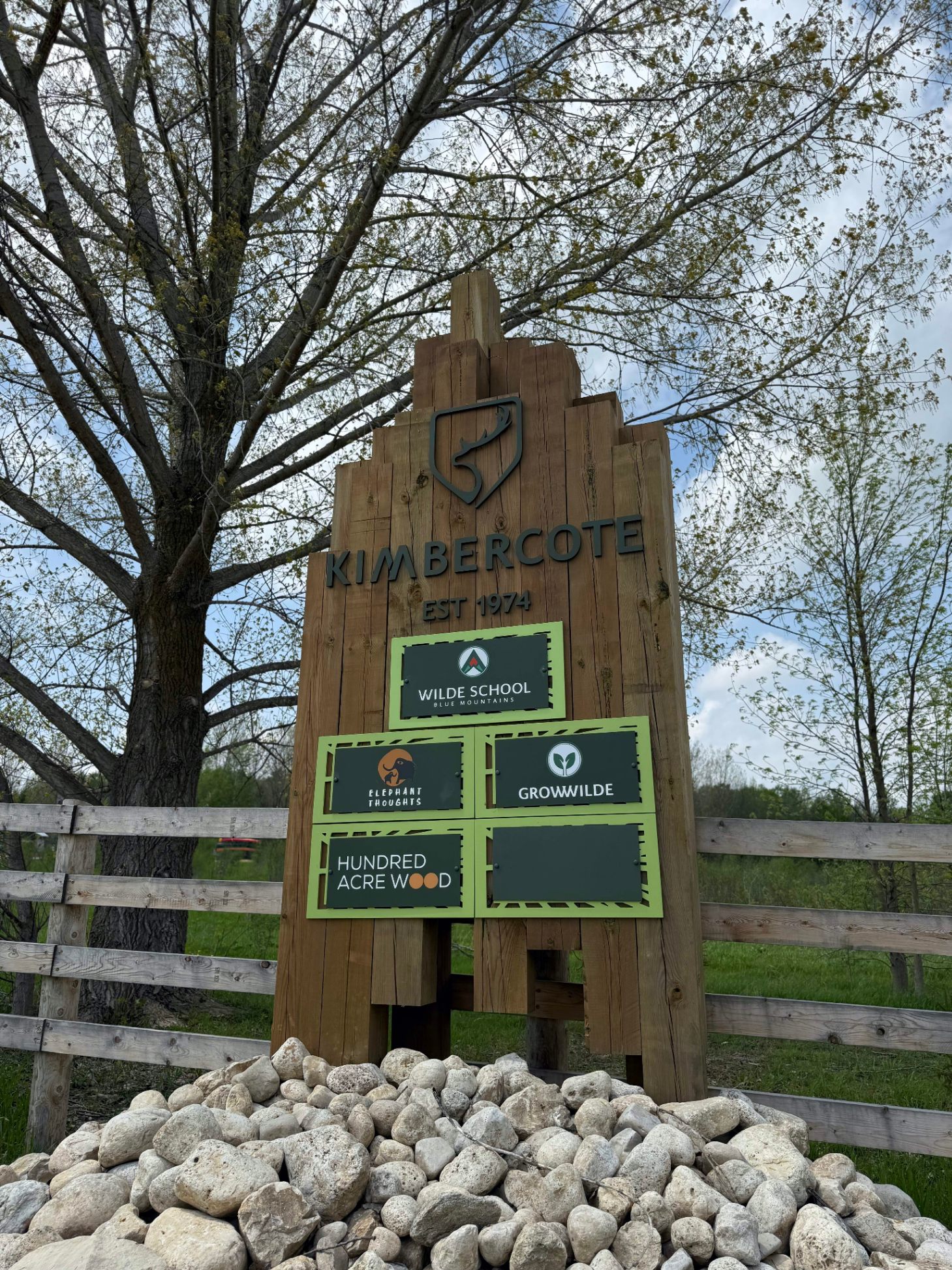 Kimbercote entrance sign — Est. 1974 — showing Wilde School, Elephant Thoughts, Grow WILDE, and Hundred Acre Wood